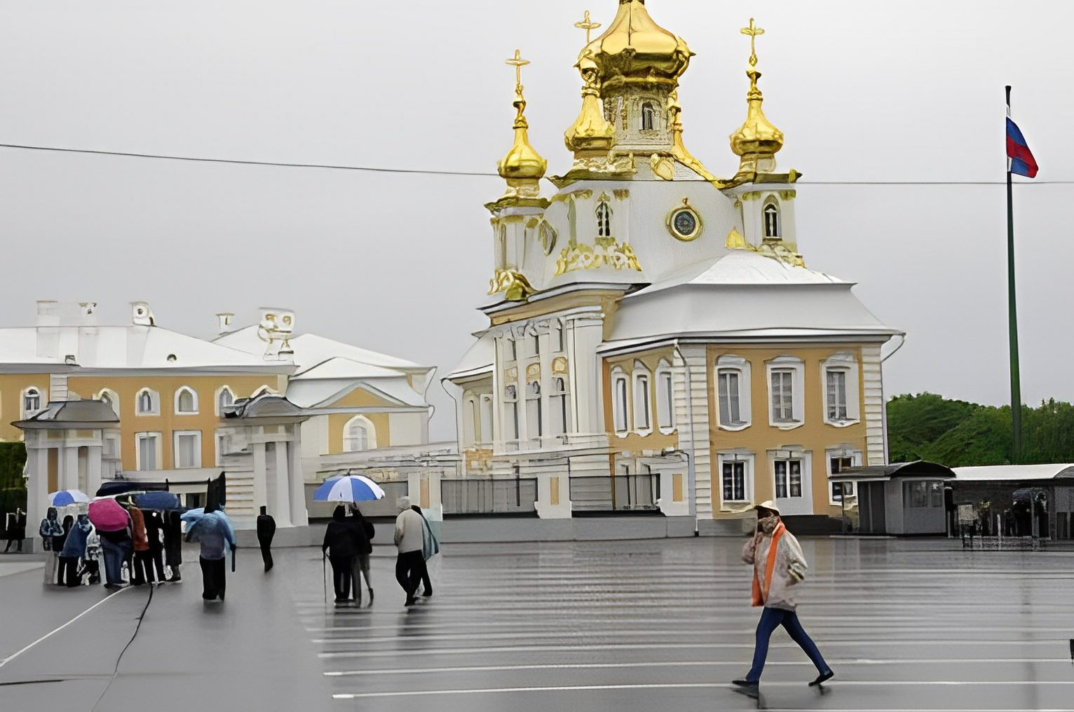 People walking near a golden-domed building.