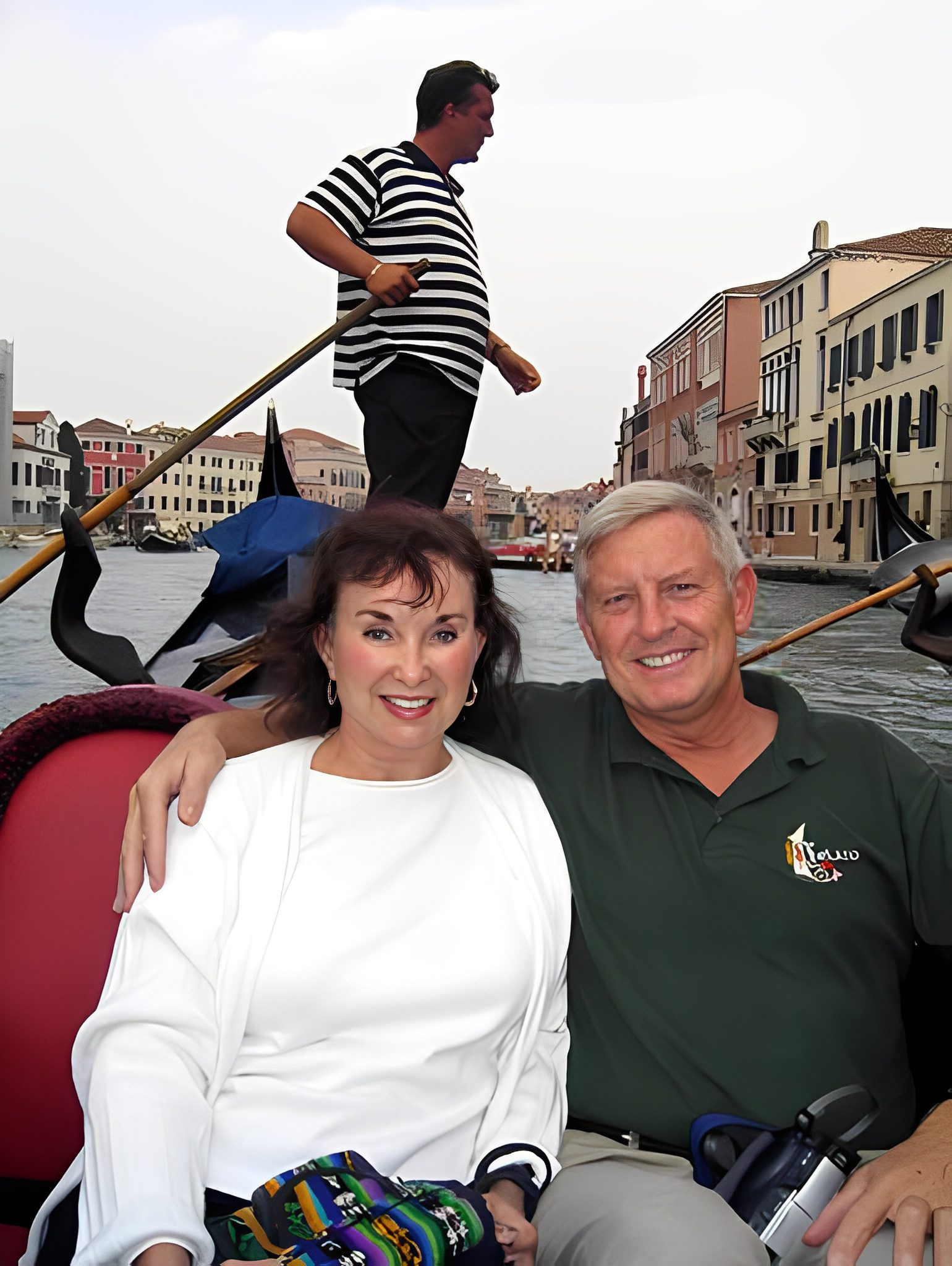 Smiling couple on gondola ride in Venice.