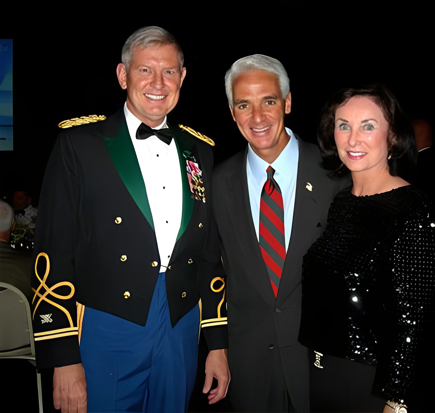 Three people posing in formal attire.