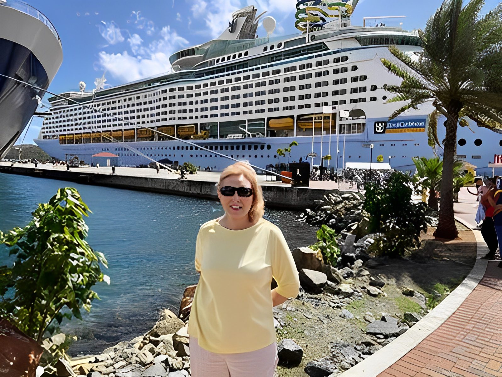 Person standing by cruise ship dockside.