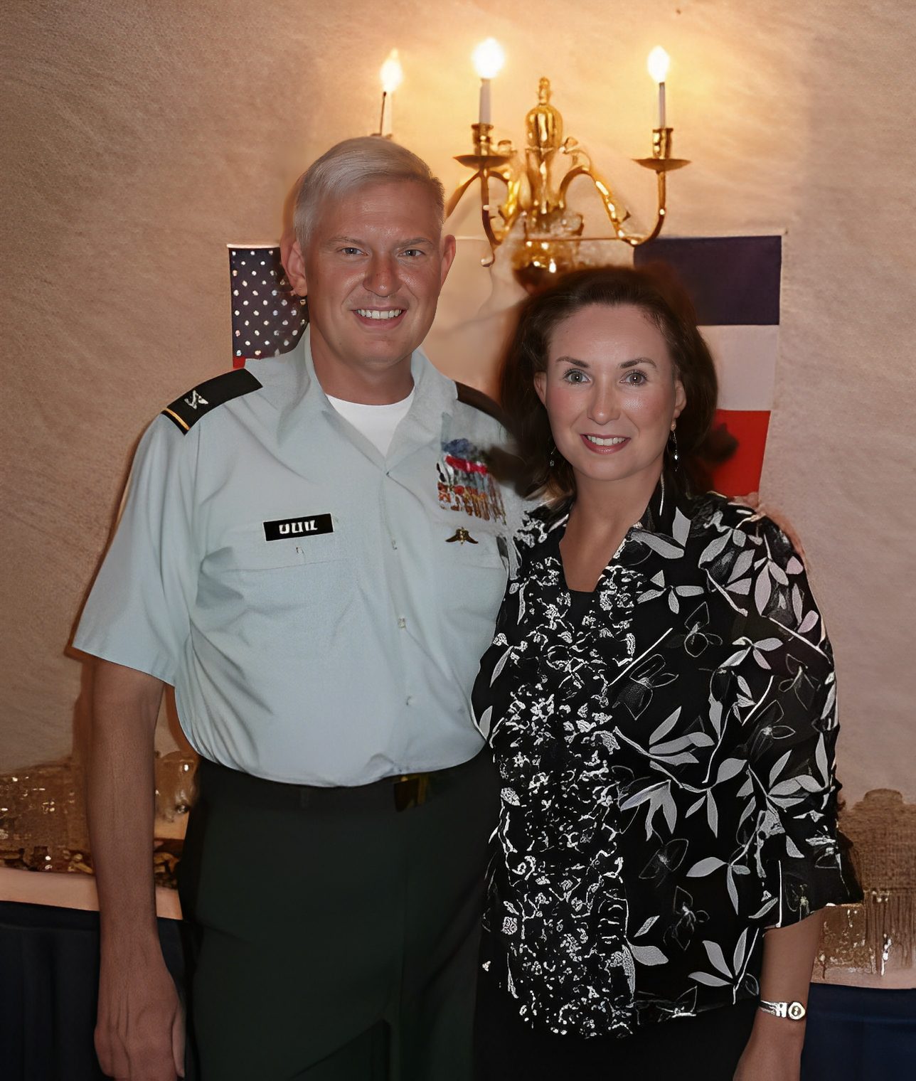 Man in military uniform with woman smiling.
