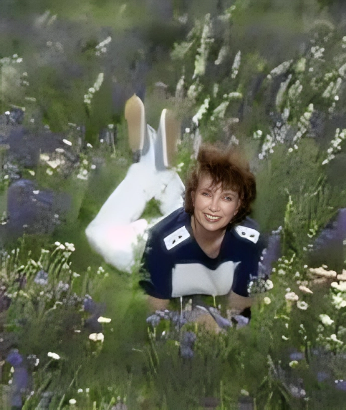 Person lying in a field of flowers.