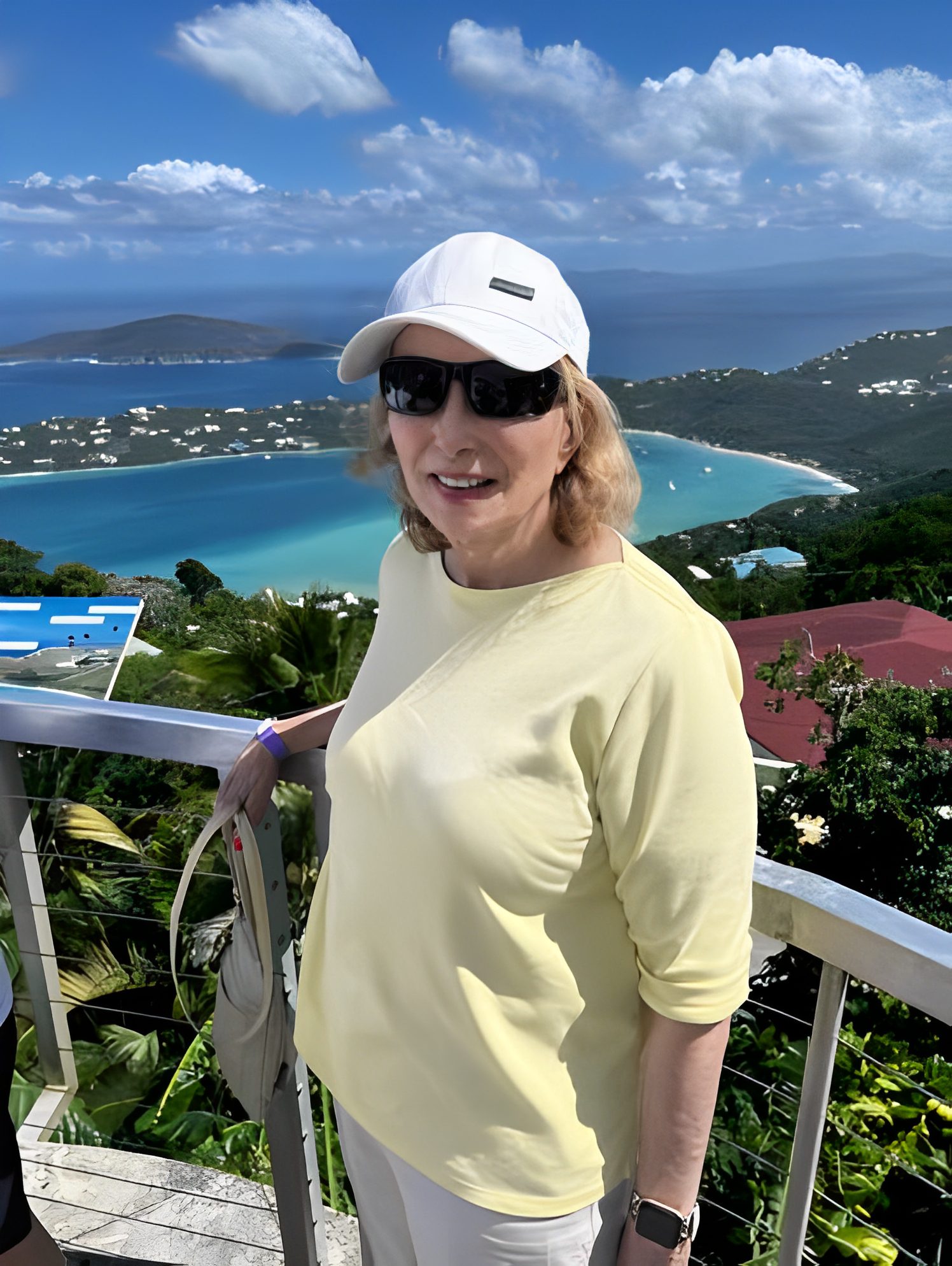 Woman in yellow enjoying tropical ocean view.