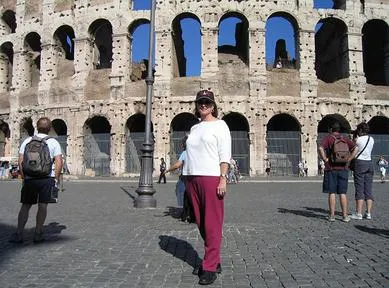 Person standing in front of the Colosseum.
