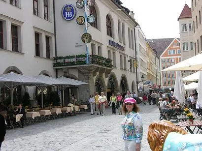Street scene with people and outdoor cafes.