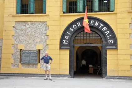 Man standing outside Maison Centrale entrance.