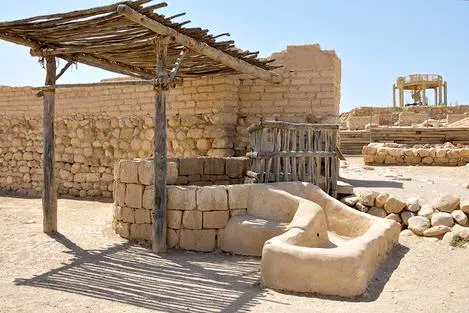 Ancient stone structure with wooden canopy.