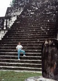 Person standing on ancient stone steps.
