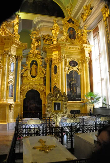 Ornate gold religious altar with tombs.