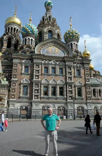 Person standing in front of ornate cathedral.
