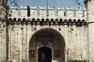 Historic stone gate with decorative carvings.
