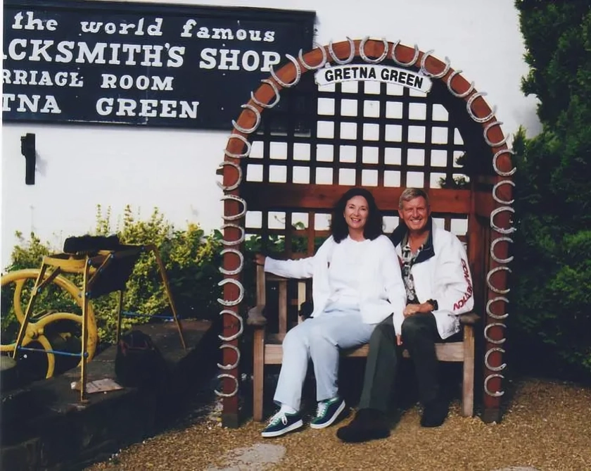 Couple sitting on bench at Gretna Green.