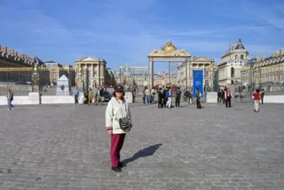 Person standing outside a large historic building.