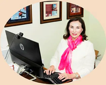 Woman working at a computer desk.