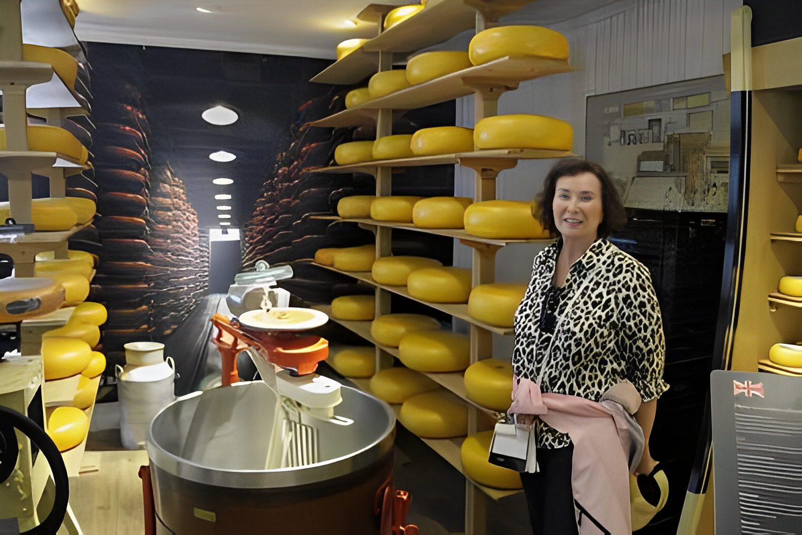 Woman standing in a cheese storage room.