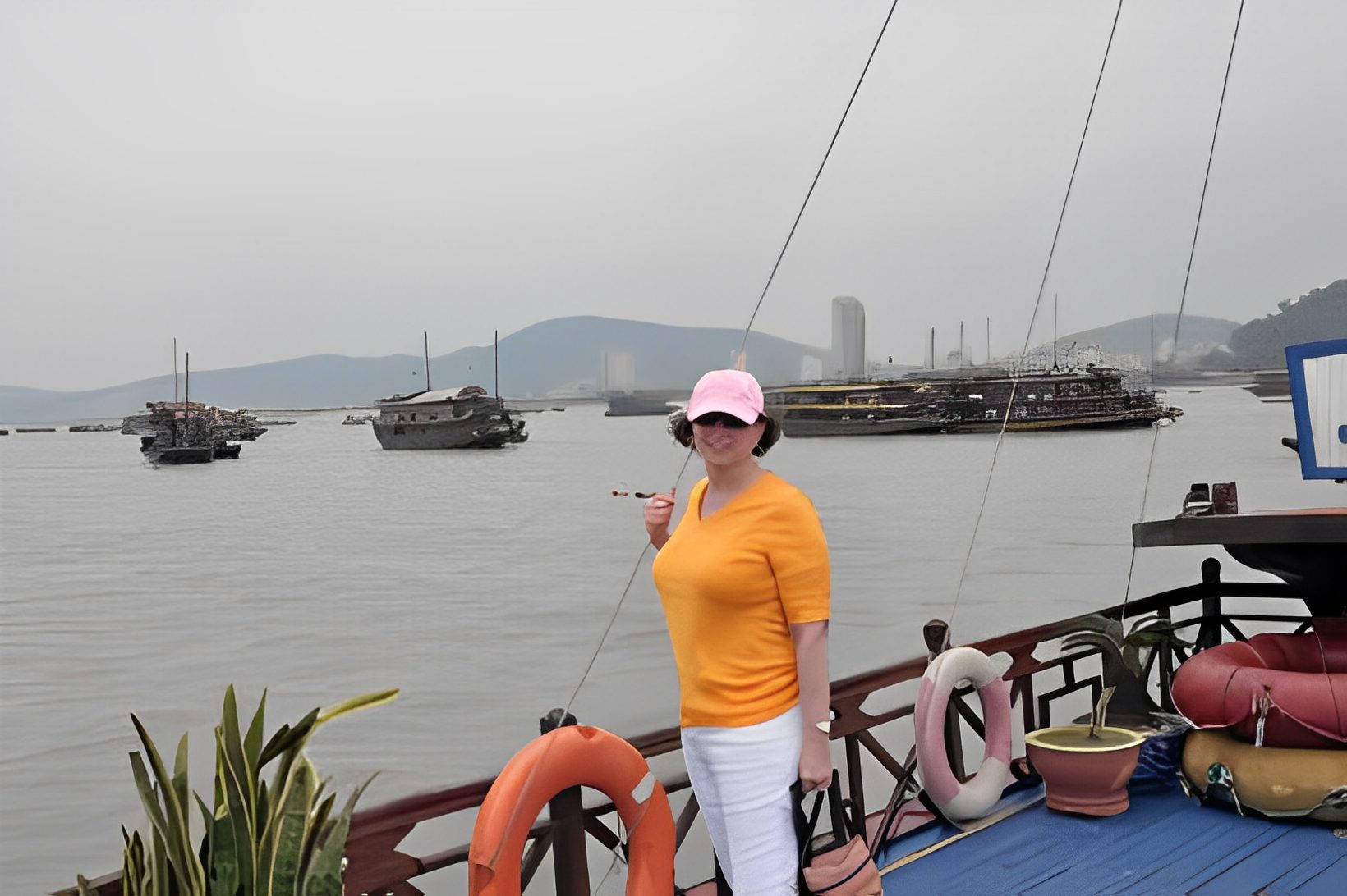 Person on boat with foggy sea background.